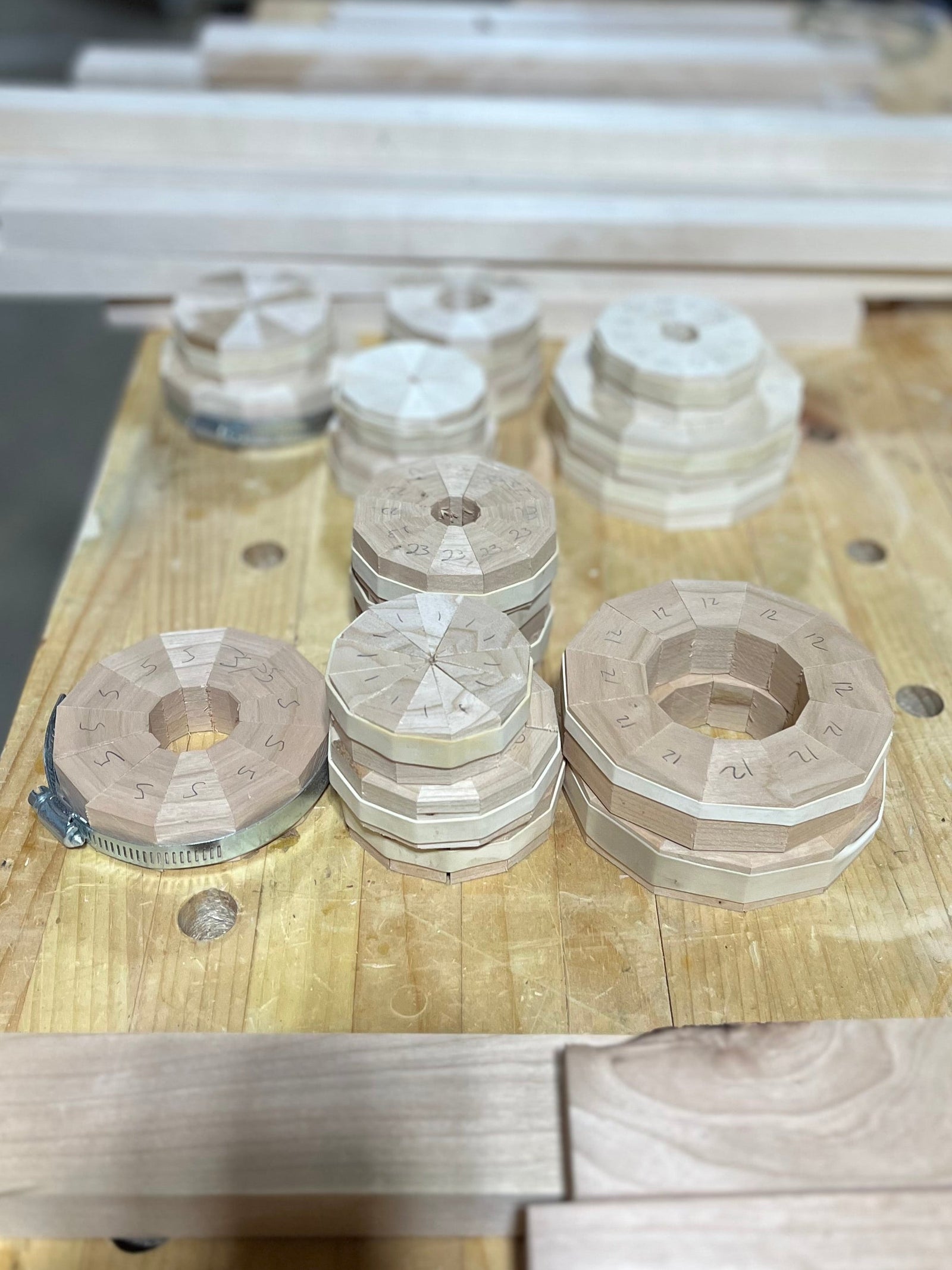 The process starts by preparing straight, flat strips of wood. These strips are milled to a consistent thickness and width so each layer of the piece will fit together cleanly.

Once the strips are prepared, they are cut into angled segments. Each segment has to be cut accurately so the pieces will form a tight ring when assembled. Even a small error in the angle can create gaps by the time the circle comes together.

Depending on the design, each ring may have 8, 12, 16, or more individual pieces. The pieces are often numbered or laid out in order to keep the grain direction, color, and pattern consistent.